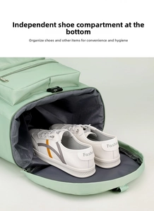Detail showing specialized bottom compartment for shoes in a green fitness travel bag