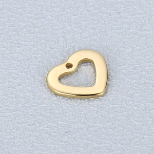Macro shot of a polished gold hollow heart pendant for DIY jewelry making