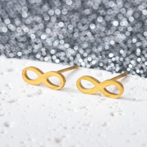 Macro shot of 18K gold plated infinity stud earrings with a matte textured surface