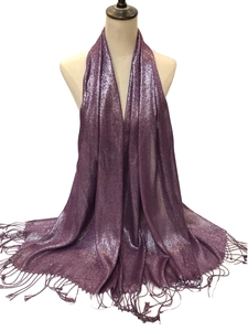 Detail of purple shimmering fabric scarf with elegant fringe trim and metallic texture