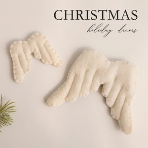 Creamy white felt Christmas angel wings ornaments set with festive green pine needles