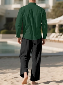 Men's dark green long sleeve linen shirt and black loose pants on a sunny beach background