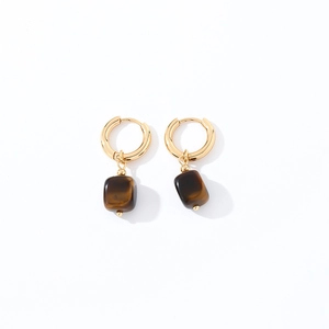 Detailed close-up of geometric square tiger eye stones on gold dangle earrings