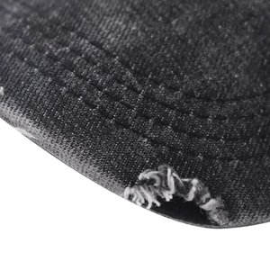 Detailed macro view of distressed washed denim baseball cap with triple stitching