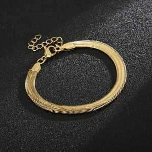 Detail of flat golden snake chain bracelet with lobster clasp and extension chain