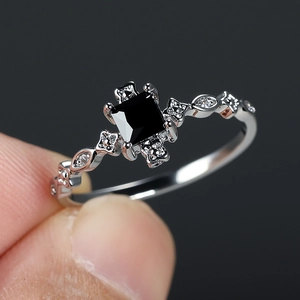 Elegant silver ring featuring a square black gemstone and petite diamond side stones