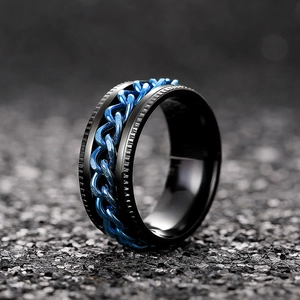 Macro view of mechanical spinning chain ring in black and electric blue metal