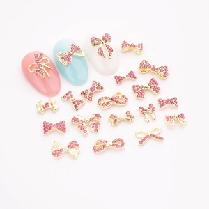 Pink rhinestone bow nail art charms in gold alloy with ribbons and assorted styles