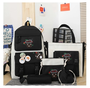 Detailed set of five black and white nylon school bags including backpack and accessories