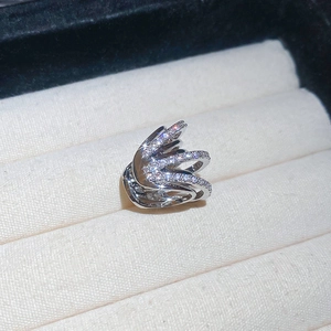 Macro shot of silver multi-layer ear cuff featuring pave-set zircons on jewelry box