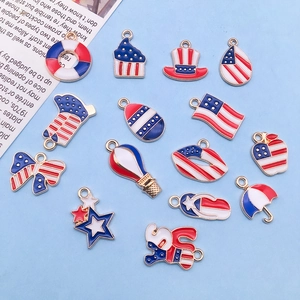 Flat lay of USA flag themed enamel pendants including stars, boots and cupcakes