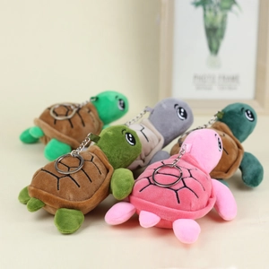 Close-up of assorted colorful plush turtle keychains in green, pink and grey colors
