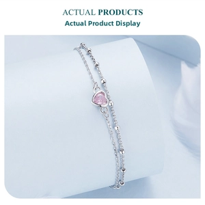 Detail of 925 silver double-layer bracelet with pink heart-shaped gemstone