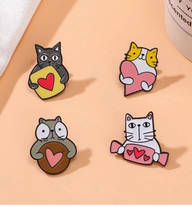 Set of four cute cartoon cat alloy brooches with heart motifs on orange background