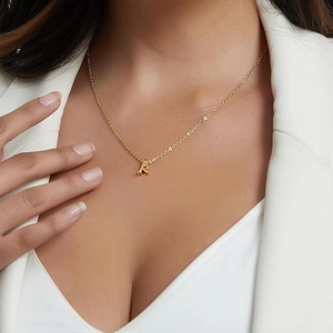 Macro view of a gold-plated necklace featuring a stylish rabbit head charm on a slim chain