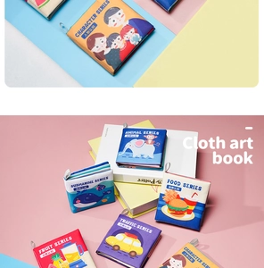 Detail of colorful baby cloth books featuring animal and fruit themes for early learning
