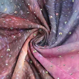 Vue détaillée du tissu en maille dégradé avec des strass scintillants et un beau drapé
