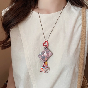 Detail of Hello Kitty resin pendant necklace with clock and beads on a braided rope