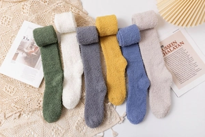 Flat lay of six pairs of soft coral fleece over-the-knee socks in various assorted colors
