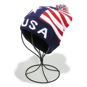 Detail of USA knit beanie with American flag stars, red white blue stripes, and pom pom