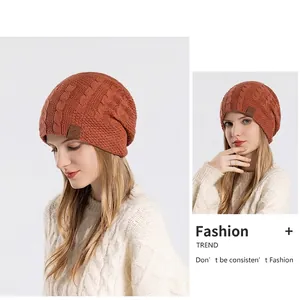 Winter orange knitted hat with thick cable knit pattern and cozy ear protection fleece