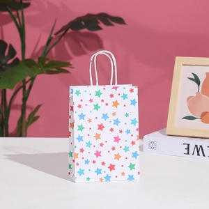 Detailed view of white paper gift bag with colorful star patterns and twisted rope handles