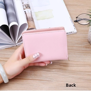 Close-up of the back of a pink PU leather wallet with a zipper and fine stitching