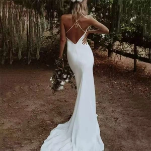 Elegant white satin bridal gown with a deep V-back and crossed thin straps in nature