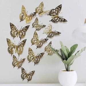 Detailed view of hollow golden butterfly wall stickers in various sizes for DIY home decor