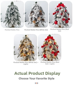 Mini tabletop flocked Christmas tree with pine cones and red ornaments on white surface