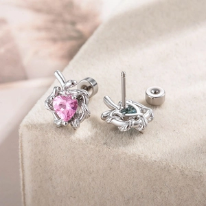 Snake-wrapped silver stud earrings featuring pink heart-shaped zircon stones