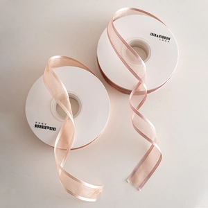 Elegant semi-transparent pink snow gauze ribbons with satin edges for Christmas gift wrapping