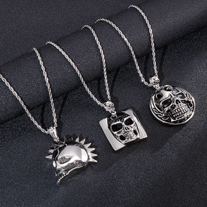 Three vintage gothic skull pendants on twist chains made of polished stainless steel