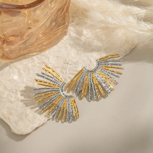 Macro detail of fan-shaped striped earrings in two-tone gold and silver finish
