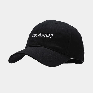 Detail of OK AND? white embroidery on a black cotton twill baseball cap with curved brim