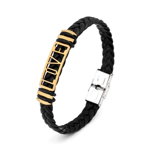 Close-up of black braided leather bracelet with golden LOVE plate and silver metal clasp