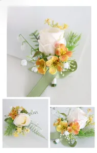 Detail of handmade champagne and orange silk roses with greenery for wedding boutonniere
