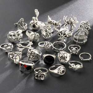 Detailed macro view of retro 24-piece punk ring set featuring skulls and spider motifs