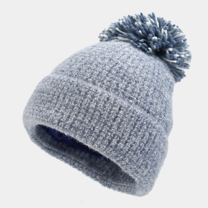 Detail of winter beanie with large dual-tone pom-pom and protective satin hair lining