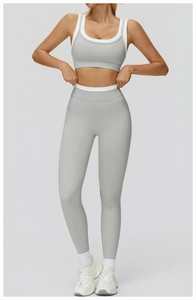 Detail of high-stretch seamless yoga set with white contrast piping and grey ribbed fabric