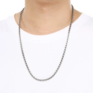 Close-up of hip-hop silver twist chain on model's neck showcasing the keel link design
