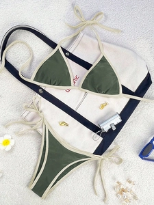 Flat lay of army green and beige bikini set with beach accessories and sunglasses