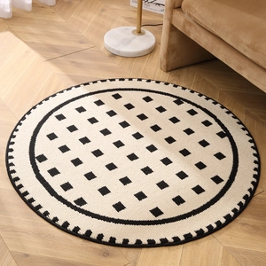 Modern cream round geometric rug with black and white woven texture on herringbone floor