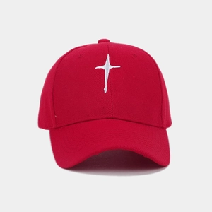 Detailed close-up of white embroidery on a red cotton twill baseball cap with 6-panel crown