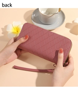 Detailed back view of a pink quilted long wallet with a wristlet and metal zipper