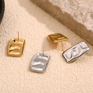 Detailed view of rectangular ripple textured earrings in gold and silver finish