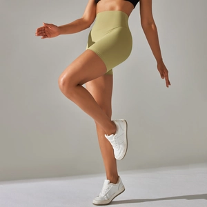 Close-up of high-waisted yoga shorts in avocado green showing seamless lifting fabric