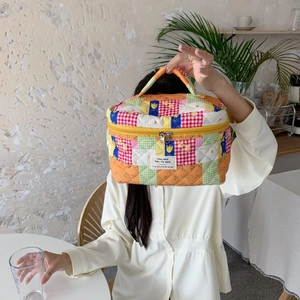 Floral patchwork cotton toiletry bag with top handle shown in a daily lifestyle scene