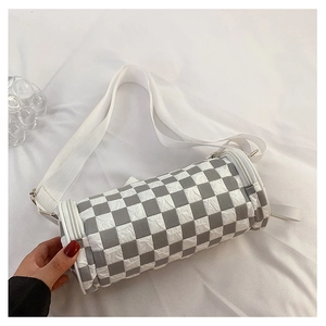 Detail of checkered cylinder shoulder bag with wide strap and textured fabric