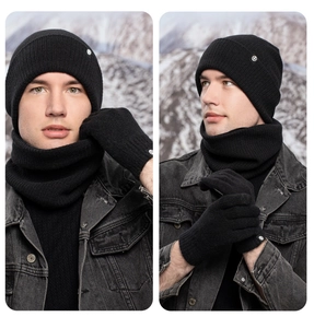 Detailed view of black knitted winter set including hat, scarf and gloves on a model